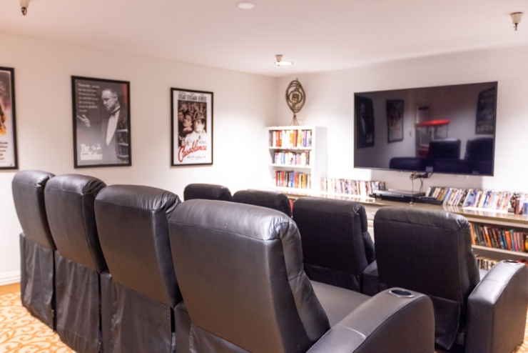 Cozy theater room with plush seating, inviting decor, and a warm atmosphere for community gatherings.
