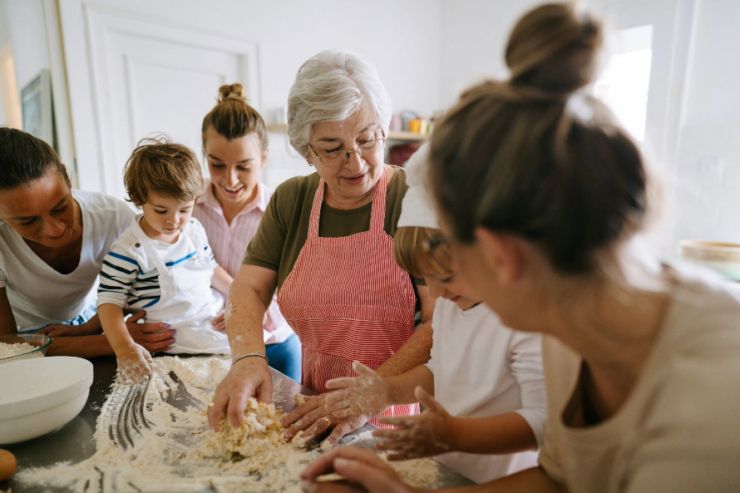 A joyful gathering in the kitchen, where generations bond over baking, creating warmth and connection.