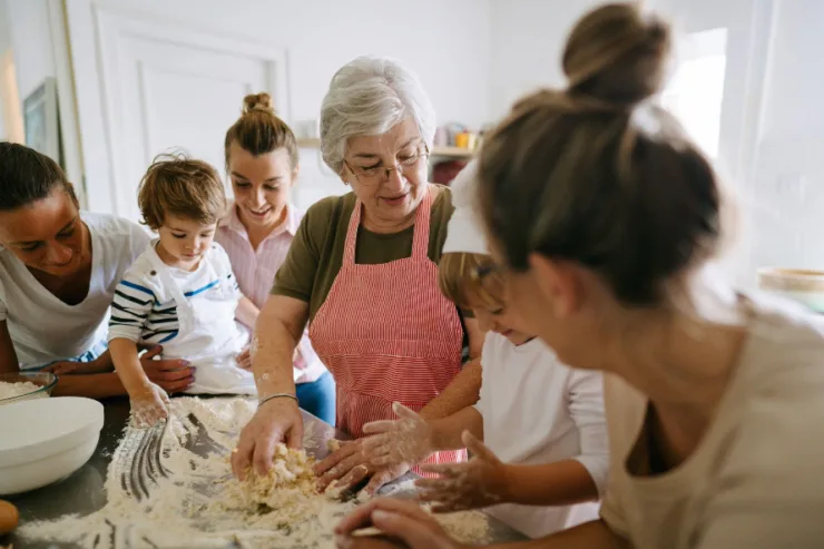 A joyful gathering in the kitchen, where generations bond over baking, creating warmth and connection.