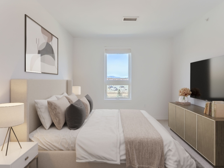 A serene bedroom filled with light, featuring cozy decor and a welcoming atmosphere for peaceful living.
