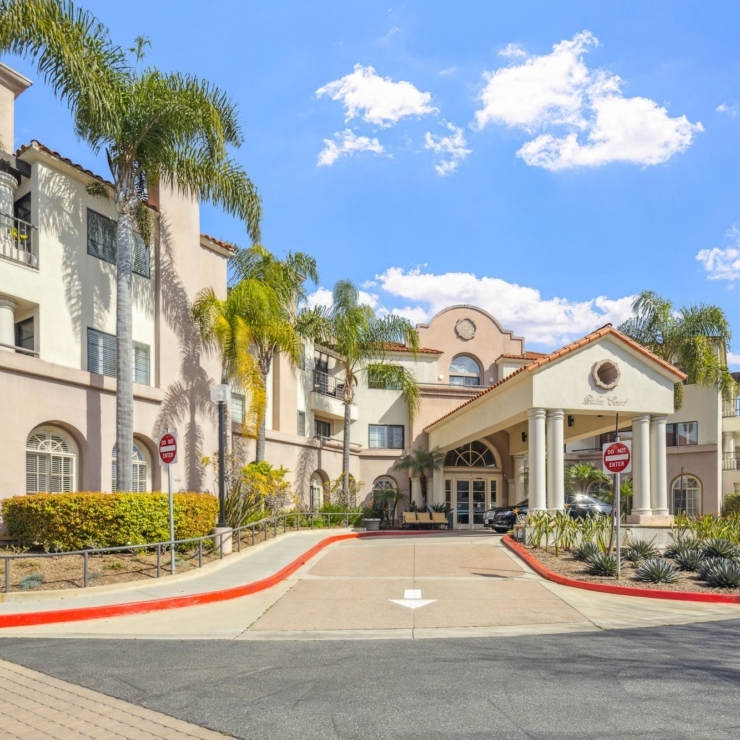 A welcoming entrance surrounded by lush greenery, inviting residents to enjoy a vibrant community.