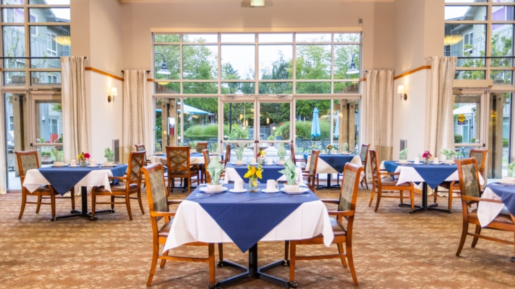 Bright and inviting dining area, filled with cheerful decor and views of a lush garden, fostering community.