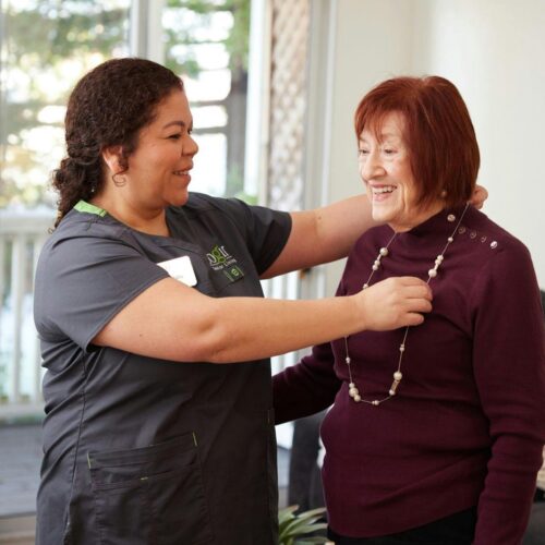 A warm interaction between caregivers and residents fosters a sense of community and belonging.