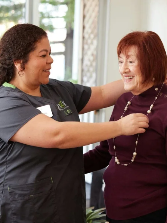 A warm interaction between caregivers and residents fosters a sense of community and belonging.