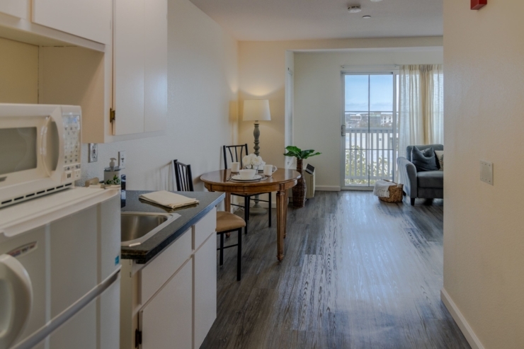 Bright, inviting space with a dining area, cozy seating, and a view, perfect for community gatherings.