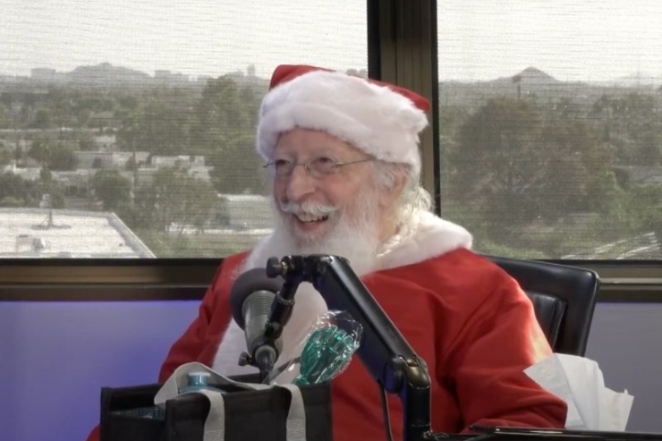 A joyful Santa shares laughter and warmth, creating a welcoming atmosphere of community and cheer.
