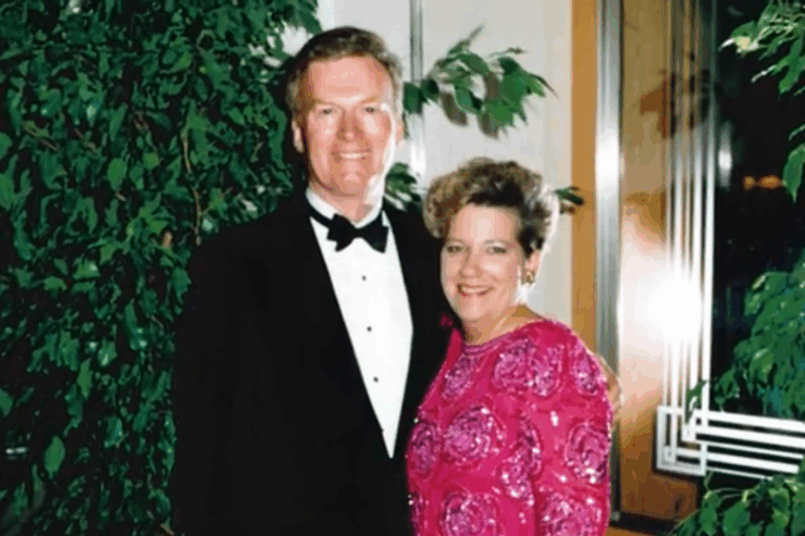 A joyful couple shares a warm moment, dressed elegantly, surrounded by lush greenery, radiating community spirit.