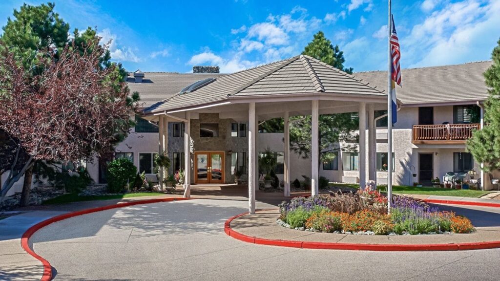 A welcoming entrance surrounded by vibrant gardens, inviting a sense of community and comfort.