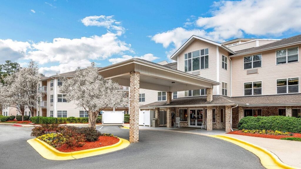 A welcoming entrance surrounded by blooming trees and vibrant landscaping, inviting community spirit.