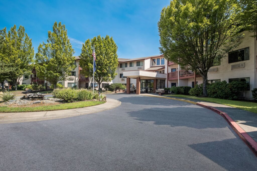 A welcoming entrance surrounded by lush greenery invites a sense of community and comfort.