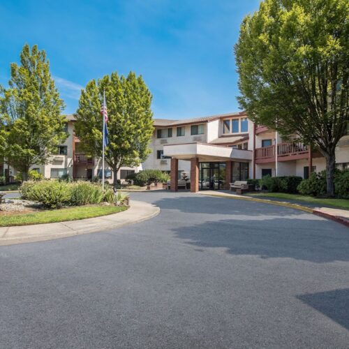 A welcoming entrance surrounded by lush greenery invites a sense of community and comfort.
