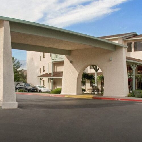 Welcoming entrance featuring lush greenery, inviting spaces, and a sense of community.