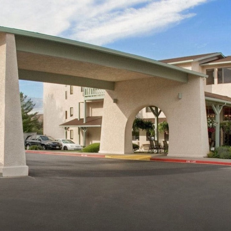 Welcoming entrance featuring lush greenery, inviting spaces, and a sense of community.