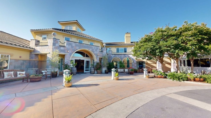 A welcoming entrance surrounded by vibrant plants and comfortable seating, radiating warmth and community.