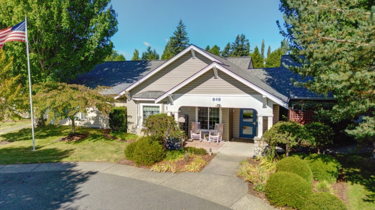 A welcoming entrance surrounded by lush greenery and cheerful seating invites a sense of community.