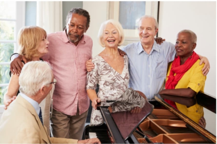 Lively gathering of friends enjoying music, sharing smiles and warmth in a bright, welcoming space.