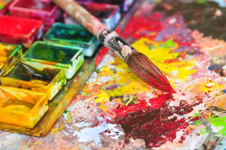 A vibrant array of paints and a brush hint at creativity and connection, inviting joyful artistry.