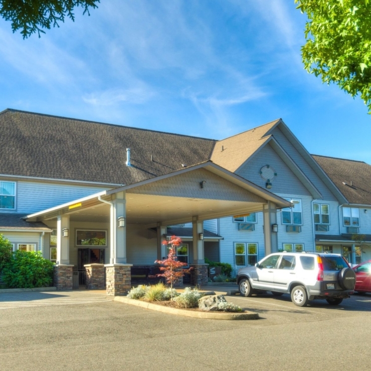 A welcoming retirement community surrounded by lush greenery, inviting residents to enjoy a vibrant life.