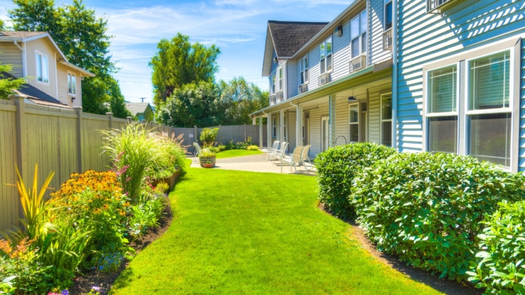 A vibrant garden path leads to a welcoming porch, inviting residents to enjoy serene moments outdoors.