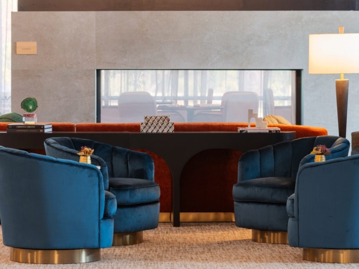 A welcoming lounge featuring plush seating, modern decor, and bright natural light, perfect for community gatherings.