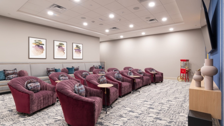 A welcoming lounge features plush seating, vibrant art, and a cheerful atmosphere, perfect for community gatherings.