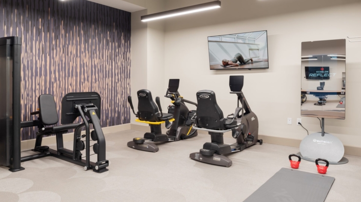A warm, inviting fitness area filled with modern equipment, promoting health and community engagement.