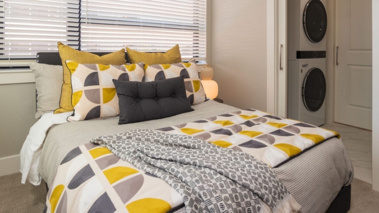 A bright, inviting bedroom with stylish decor, promoting comfort and a sense of community.