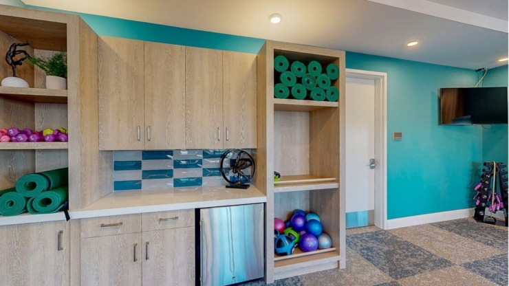 A vibrant, welcoming fitness area filled with colorful equipment, promoting community and wellness.