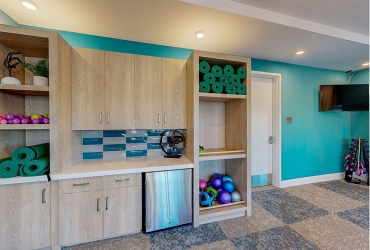 A vibrant, welcoming fitness area filled with colorful equipment, promoting community and wellness.