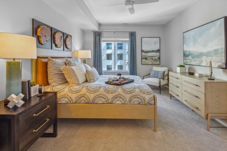A welcoming bedroom filled with light, featuring elegant decor and a comfortable atmosphere for relaxation.