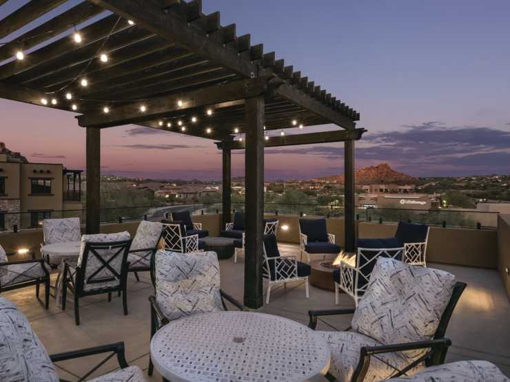 Elegant outdoor seating under warm lights, inviting community gatherings at twilight.