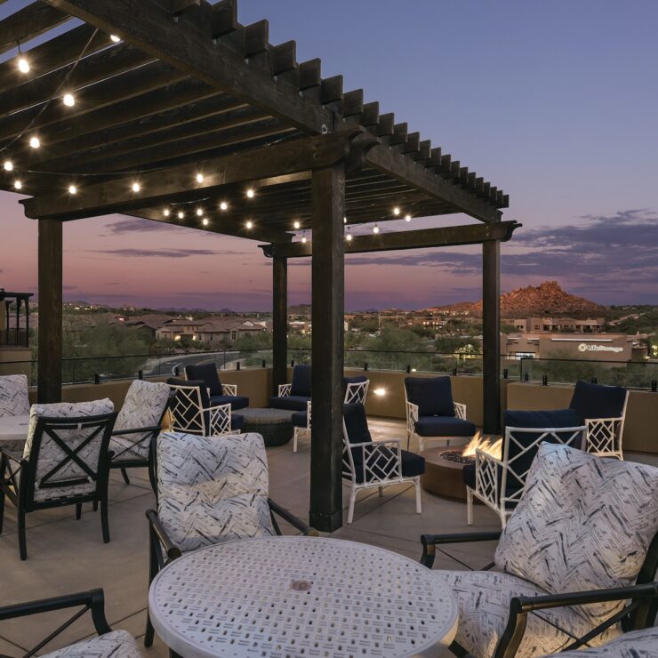 Elegant outdoor seating under warm lights, inviting community gatherings at twilight.
