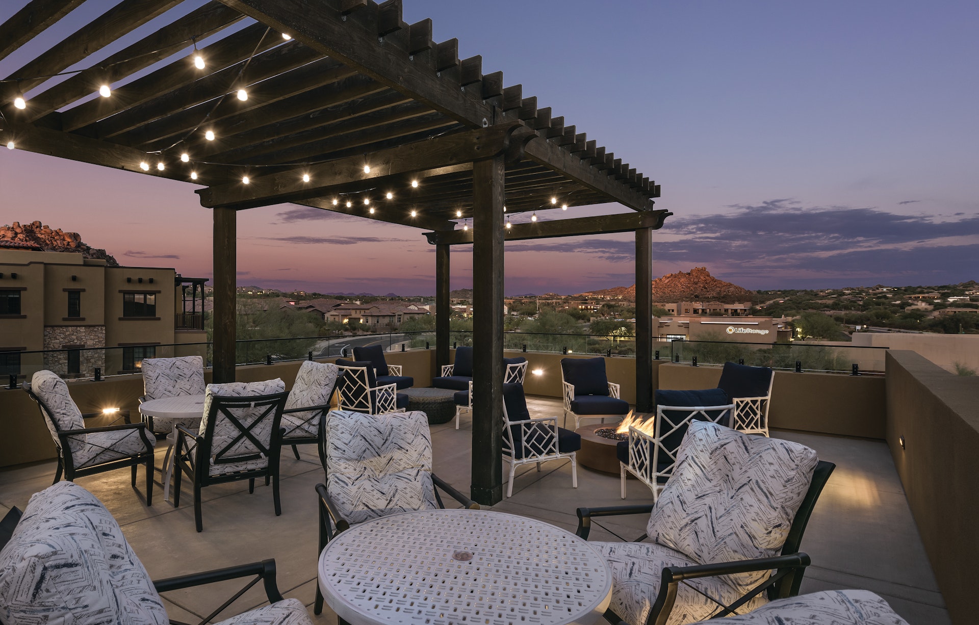 Elegant outdoor seating under warm lights, inviting community gatherings at twilight.