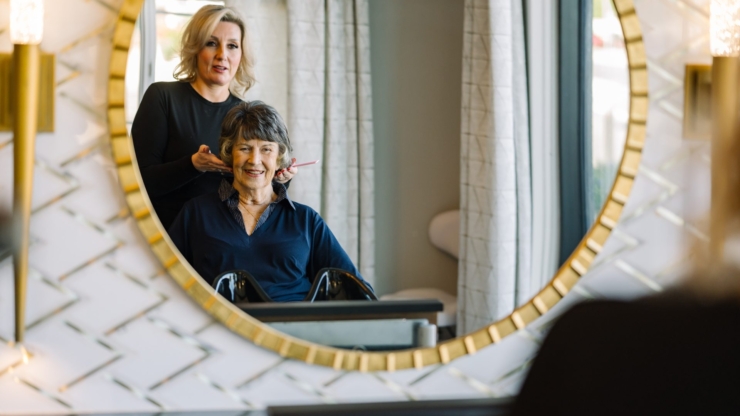 A warm moment shared in the salon, reflecting joy and care in a welcoming community space.