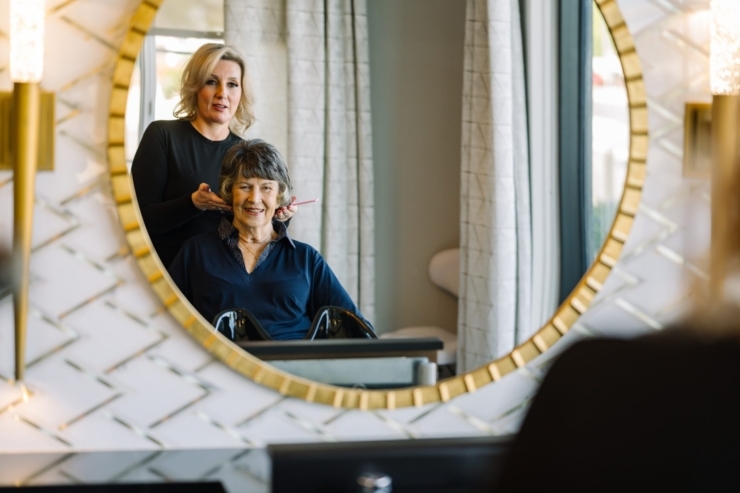 A warm moment shared in the salon, reflecting joy and care in a welcoming community space.
