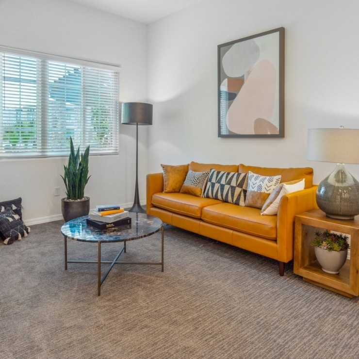 Bright and inviting, this warm space features comfortable seating and greenery, perfect for community gatherings.