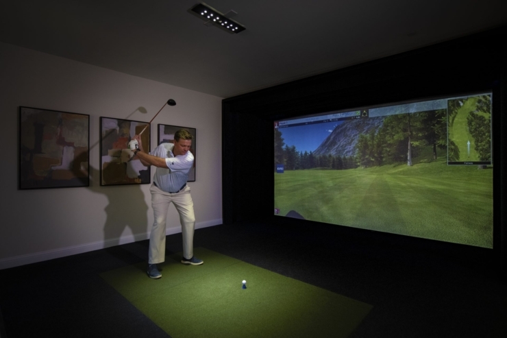 Engaging in indoor golf, residents enjoy a lively activity in a welcoming, vibrant setting.