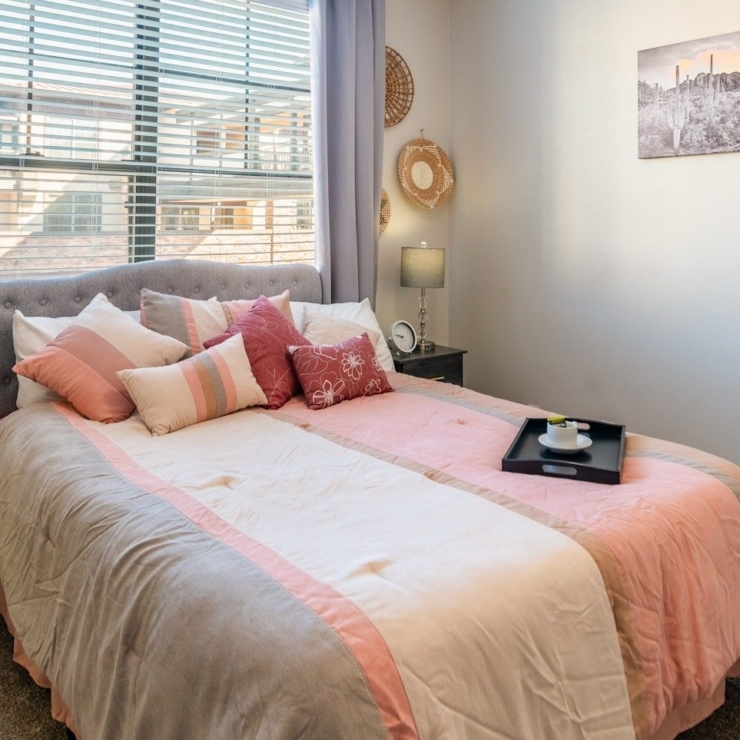 A serene bedroom filled with soft colors, inviting decor, and natural light, perfect for relaxation.