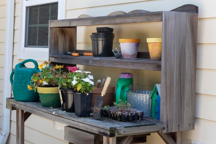 A charming gardening station filled with vibrant flowers and tools, inviting community and creativity.