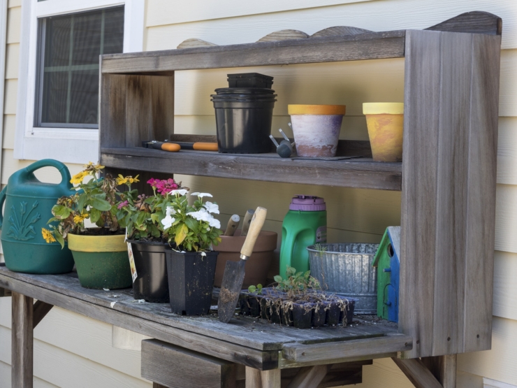 A charming gardening station filled with vibrant flowers and tools, inviting community and creativity.