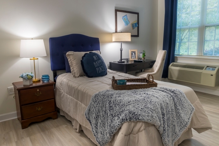 A welcoming bedroom with soft lighting and personal touches, fostering comfort and community.
