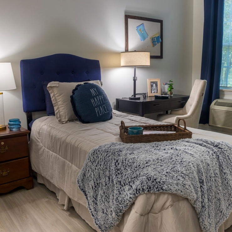 A serene bedroom setting, featuring a cozy bed, inviting decor, and warm lighting, promoting comfort and community.