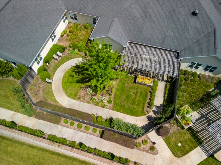 Inviting pathways weave through lush gardens, creating a serene space for community connection and relaxation.