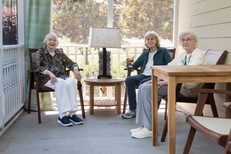 A welcoming gathering of residents enjoying each other's company in a bright, cheerful setting.