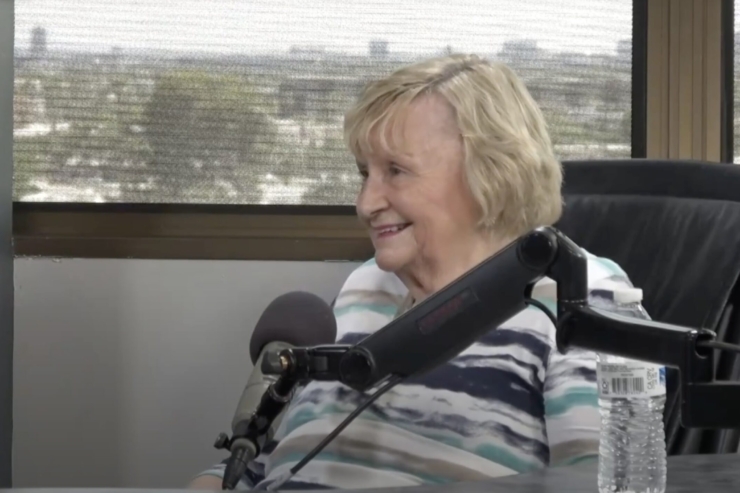 A cheerful resident shares a moment of joy in a bright, welcoming space, embodying community spirit.