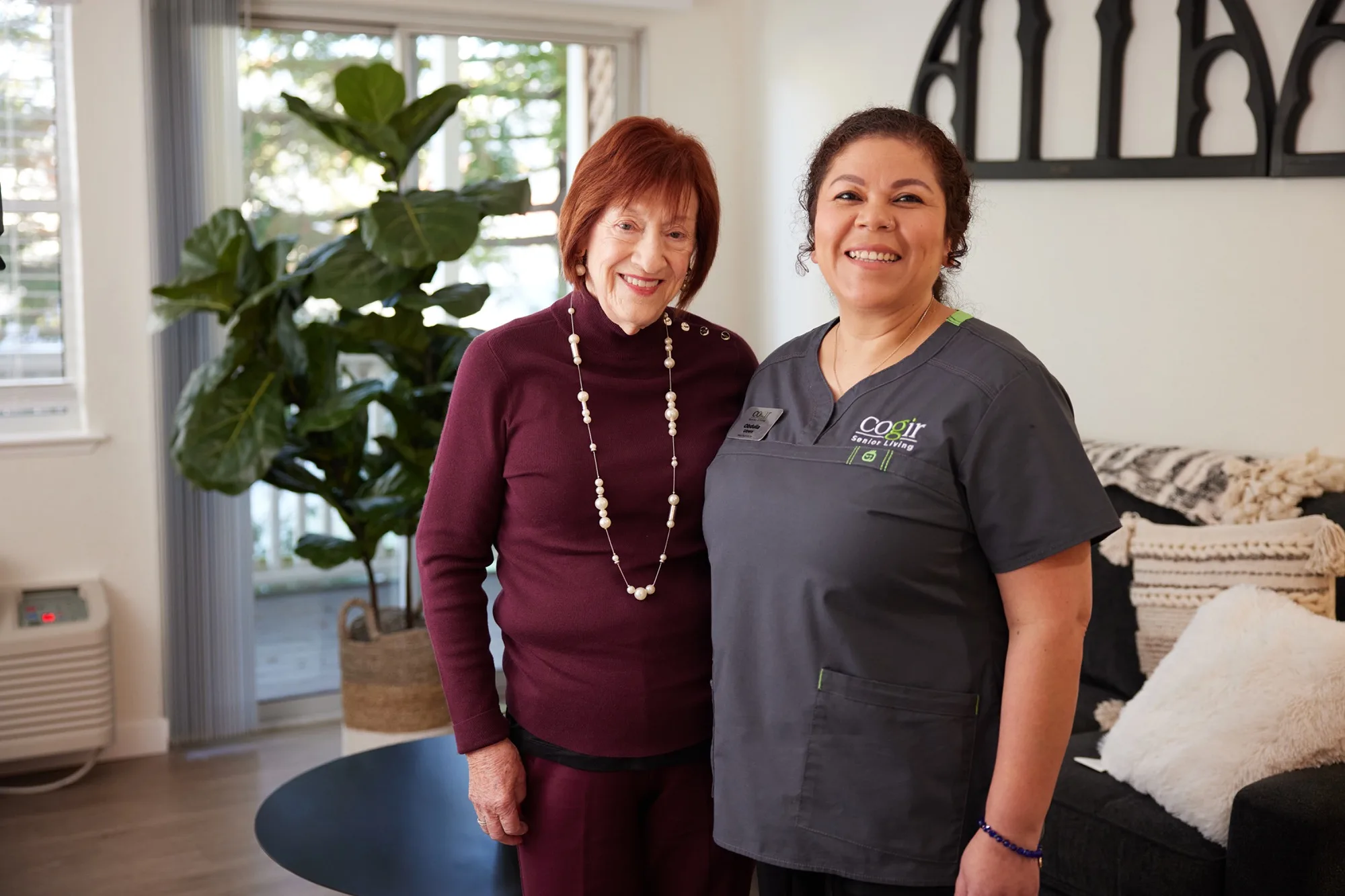 A warm moment between a resident and staff member, highlighting community and care in a welcoming space.