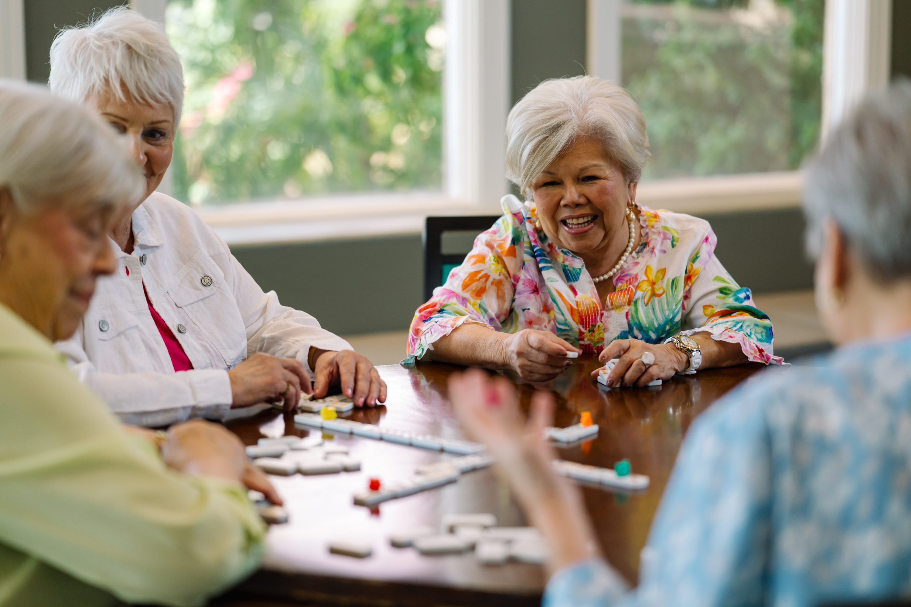 A lively gathering of friends enjoying a game, laughter, and connection in a bright, welcoming space.