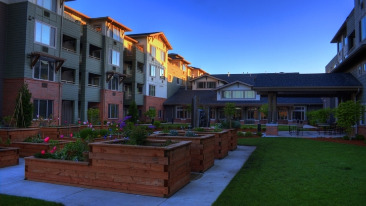A welcoming community space with vibrant gardens and comfortable residences, perfect for relaxation.