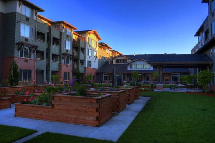 A welcoming community space with vibrant gardens and comfortable residences, perfect for relaxation.