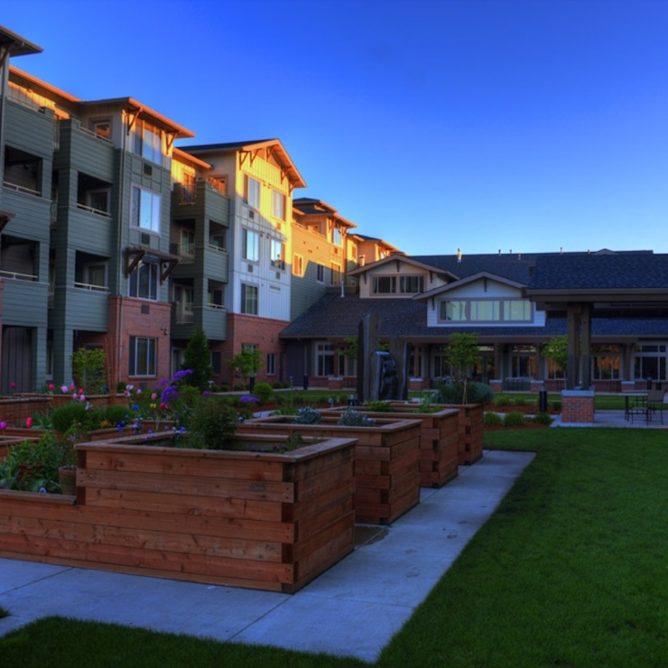 A welcoming community space with vibrant gardens and comfortable residences, perfect for relaxation.
